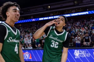 Lincoln Southwest’s Kobi Kerr (32) is biting the W after winning a high school basketball game against Westside in the semifinals of the NSAA boys state basketball tournament on March 11, 2026 in Lincoln, Nebraska. Photo By Jack Stephens.