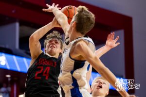 St. Mary's Cardinal Gage Hedsome (24) fights to make a tough layup through defenders during a boys state semifinal basketball game, Mar. 13, 2026, Lincoln, Nebraska. Photo by Braden Cochran.