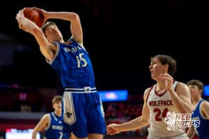 Guardian Angel Central Catholic forward Hudson Bramlet (15 leaps to steal a rebound from EPPJ forward Max Henn (24) during a boys state semifinal basketball game, Mar. 13, 2026, Lincoln, Nebraska. Photo by Braden Cochran.