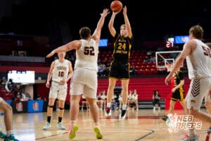 McCool Junction's Jaxon McDonald (24) shoots over East Butler's Elliot Bouc (52) during a Boys State Championship First Round basketball game Thursday, March 12, 2026, in Lincoln, Nebraska. Photo by Jackson D. Luethje.