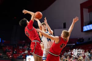 Norfolk Lutheran's Gavin Feddern (14) shoots over Mead’s Tony Engel (10) and Abe Lee (41) during a Boys State Championship First Round basketball game Thursday, March 12, 2026, in Lincoln, Nebraska. Photo by Jackson D. Luethje.