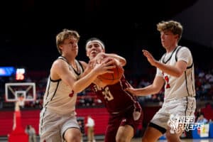 Gothenburg's Braden Ehlers (30) and Auburn's's Brenton Wenzl (3) reach for ball during a Boys State Championship First Round basketball game Thursday, March 12, 2026, in Lincoln, Nebraska. Photo by Jackson D. Luethje.