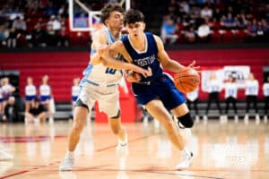 Lincoln Christian's Ben Mooss (1) guarded by Ashland-Greenwood's Logan Fangmeyer (10) during a Boys State Championship First Round basketball game Thursday, March 12, 2026, in Lincoln, Nebraska. Photo by Jackson D. Luethje.