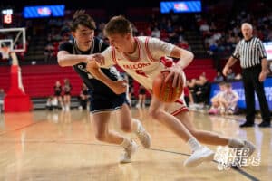 DC West's Trey Olsen (5) drives onGrand Island Central Catholic's Mason Vasquez (21) during a Boys State Championship First Round basketball game Thursday, March 12, 2026, in Lincoln, Nebraska. Photo by Jackson D. Luethje.