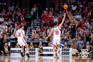 Purdue Boilermaker guard C.J. Cox (0) makes a three-point basket against Nebraska Cornhusker forward Pryce Sandfort (21) during the Big Ten Men’s Basketball Championships quarter-final on Friday, March 13, 2026, in Chicago, Illinois. Photo by John S. Peterson.