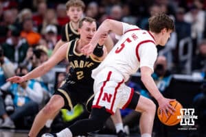 Nebraska Cornhusker forward Braden Frager (5) dribbles the ball past Purdue Boilermaker guard Fletcher Loyer (2) during the Big Ten Men’s Basketball Championships quarter-final on Friday, March 13, 2026, in Chicago, Illinois. Photo by John S. Peterson.