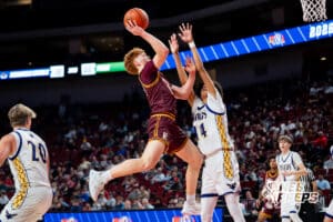 Papillion-La Vista's Preston Avalon (12) layup over Bellevue West's Pierce Parker (14) during a Boys State Championship First Round basketball game Wednesday, March 11, 2026, in Lincoln, Nebraska. Photo by Jackson D. Luethje.