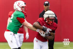Nebraska Cornhusker quarterback Daniel Kaelin (12) hands the ball off to Jamal Rule during spring football practice on Tuesday, March 10, 2026, in Lincoln, Nebraska. Photo by John S. Peterson.