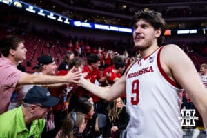Nebraska Cornhusker forward Berke Büyüktuncel (9) gives the fans high fives after the win against the Iowa Hawkeyes during a college basketball game on Sunday, March 8, 2026, in Lincoln, Nebraska. Photo by John S. Peterson.