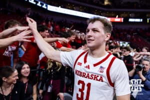 Nebraska Cornhusker guard Cale Jacobsen (31) gives the fans high fives after the win over the Iowa Hawkeyes during a college basketball game on Sunday, March 8, 2026, in Lincoln, Nebraska. Photo by John S. Peterson.