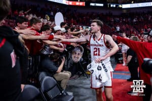 Nebraska Cornhusker forward Pryce Sandfort (21) gives the fans high fives after the win over the Iowa Hawkeyes during a college basketball game on Sunday, March 8, 2026, in Lincoln, Nebraska. Photo by John S. Peterson.