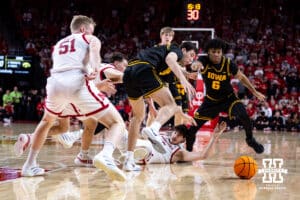 Nebraska Cornhuskers and the Iowa Hawkeyes go after a loose ball in the second half during a college basketball game on Sunday, March 8, 2026, in Lincoln, Nebraska. Photo by John S. Peterson.