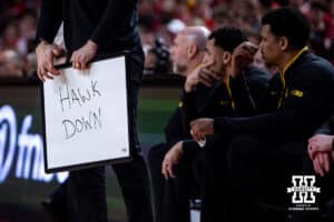 Iowa Hawkeyes coach holds a sign with a play against the Nebraska Cornhuskers during a college basketball game on Sunday, March 8, 2026, in Lincoln, Nebraska. Photo by John S. Peterson.