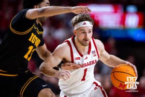 Nebraska Cornhusker guard Sam Hoiberg (1) drives the lane Iowa Hawkeye guard Kael Combs (11) in the first half during a college basketball game on Sunday, March 8, 2026, in Lincoln, Nebraska. Photo by John S. Peterson.