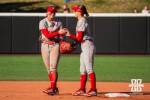 Nebraska Cornhuskers Ava Kuszak (left) and Lauren Camenzind (right) share a high five after a play during a softball game at Bowlin Field on March 7th, 2026, in Lincoln, Nebraska. Photo by Collin Stilen.