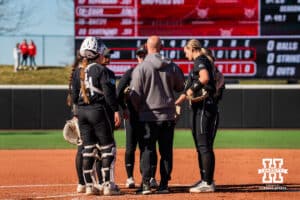Omaha Mavericks meet at the plate to talk during a softball game at Bowlin Field on March 7th, 2026, in Lincoln, Nebraska. Photo by Collin Stilen.