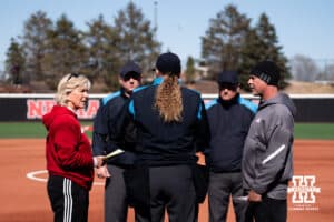 Nebraska Cornhusker head coach Rhonda Revelle and Omaha Maverick head coach Mike Heard meet at the plate during a softball game at Bowlin Field on March 7th, 2026, in Lincoln, Nebraska. Photo by Collin Stilen.