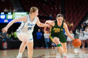 Lincoln Pius X's Kate Miller (42) guarded by Bennington's Allie John (34) during a Girls State Championship Semifinal Round basketball game Friday, March 6, 2026, in Omaha, Nebraska. Photo by Jackson D. Luethje.
