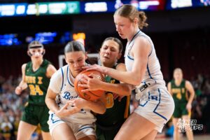 Lincoln Pius X's Ava Markowski (40) fights for the ball with Bennington's Harper Bohaboj (12) and Macie Reiner (15) during a Girls State Championship Semifinal Round basketball game Friday, March 6, 2026, in Omaha, Nebraska. Photo by Jackson D. Luethje.