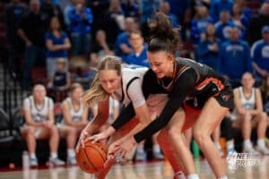 Malcolm's Payton Dolliver (12) fights for possession with Fort Calhoun's Ansley Elofson (31) during a Girls State Championship Semifinal Round basketball game Friday, March 6, 2026, in Lincoln, Nebraska. Photo by Jackson D. Luethje.