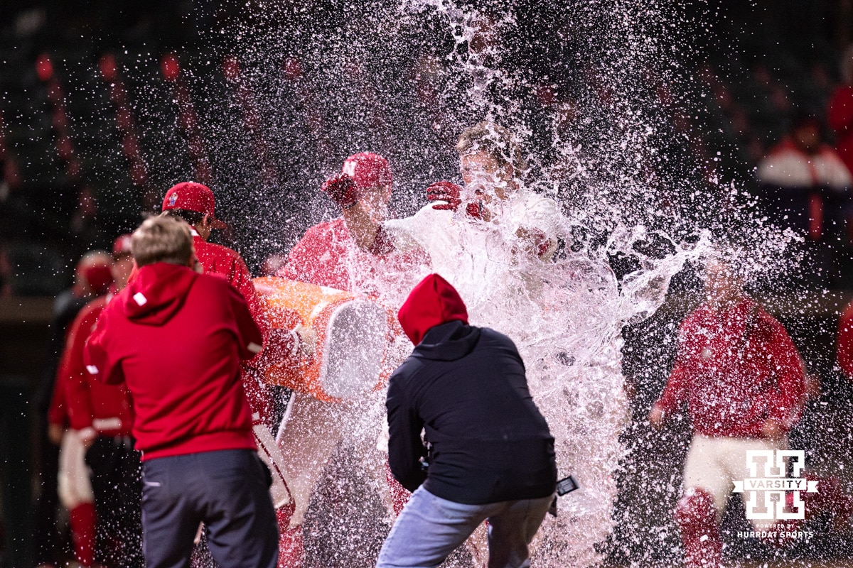 Nebraska Baseball v Michigan State Mar 6, 2026 | Hail Varsity Nebraska Cornhusker Case Sanderson (14) is soaked with water, celebrating the walk-off win over the Michigan State Spartans in the 10th inning during a college baseball game on Friday, March 6, 2026, in Lincoln, Nebraska. Photo by John S. Peterson.