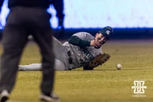 Michigan State Spartan outfielder Nick Williams (10) drops the ball from Nebraska Cornhusker Case Sanderson (14) double in the eighth during a college baseball game on Friday, March 6, 2026, in Lincoln, Nebraska. Photo by John S. Peterson.