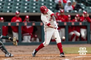 Nebraska Cornhusker infielder Cole Kitchens (12) singles against the Michigan State Spartans in the fourth inning during a college baseball game on Friday, March 6, 2026, in Lincoln, Nebraska. Photo by John S. Peterson.
