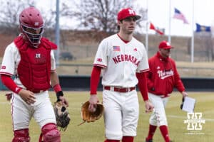 Nebraska Cornhusker starting pitcher Ty Horn (2), along with catcher Jeter Worthley, and coach Rob Childress, walk to the dugout to take on the Michigan State Spartans during a college baseball game on Friday, March 6, 2026, in Lincoln, Nebraska. Photo by John S. Peterson.