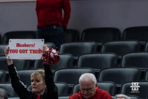 Nebraska Cornhusker fan holds a sign during a college basketball game against Indiana on Mar 4th, 2026, in Indianapolis, Indiana. Photo by Brandon Tiedemann