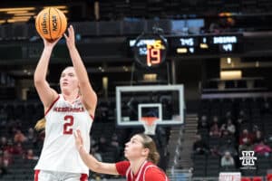 Nebraska Cornhusker Logan Nissley (2) shoots through two defenders during a college basketball game against Indiana on Mar 4th, 2026, in Indianapolis, Indiana. Photo by Brandon Tiedemann