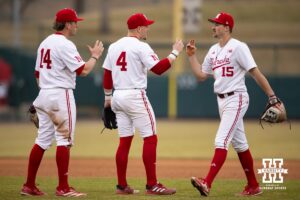 Nebraska Cornhuskers Josh Overbeek (4), and Case Sanderson (14), and Dylan Carey (15) celebrates the win against the Omaha Mavericks during a college baseball game on Tuesday, March 3, 2026, in Lincoln, Nebraska. Photo by John S. Peterson.