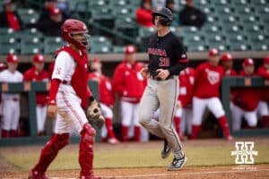 Nebraska Cornhusker pitcher Kevin Mannell (20) scores a run in the ninth inning against the Nebraska Cornhuskers during a college baseball game on Tuesday, March 3, 2026, in Lincoln, Nebraska. Photo by John S. Peterson.