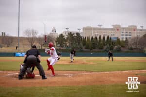 Omaha Maverick pitcher Brayden Curtis (5) throws a pitch against Nebraska Cornhusker outfielder Devin Nunez (16) in the four inning during a college baseball game on Tuesday, March 3, 2026, in Lincoln, Nebraska. Photo by John S. Peterson.