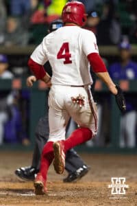 Nebraska Cornhusker Josh Overbeek (4) scores a run from the Rhett Stokes single in the ninth inning for the walk-off win against the Kansas State Wildcats during a college baseball game at Haymarket Park on Tuesday, April 28, 2026, in Lincoln, Neb. Photo by John S. Peterson.