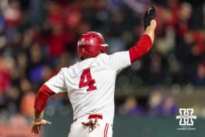 Nebraska Cornhusker Josh Overbeek (4) runs home from the Rhett Stokes single in the ninth inning for the walk-off win against the Kansas State Wildcats during a college baseball game at Haymarket Park on Tuesday, April 28, 2026, in Lincoln, Neb. Photo by John S. Peterson.