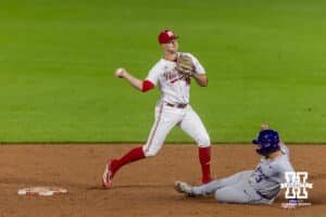 Nebraska Cornhusker infielder Dylan Carey (15) throws to first after forcing out Kansas State Wildcat Bear Madliak (3) for a double-play in the eighth inning during a college baseball game at Haymarket Park on Tuesday, April 28, 2026, in Lincoln, Neb. Photo by John S. Peterson.