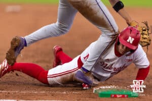 Nebraska Cornhusker Will Jesske (13) dives back to first against the Kansas State Wildcats in the fifth inning during a college baseball game at Haymarket Park on Tuesday, April 28, 2026, in Lincoln, Neb. Photo by John S. Peterson.