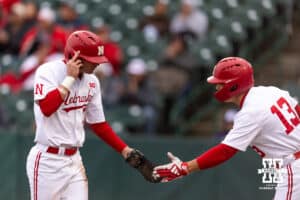 Nebraska Cornhusker Mac Moyer (17) celebrates his run with Will Jesske against the Kansas State Wildcats in the first inning during a college baseball game at Haymarket Park on Tuesday, April 28, 2026, in Lincoln, Neb. Photo by John S. Peterson.