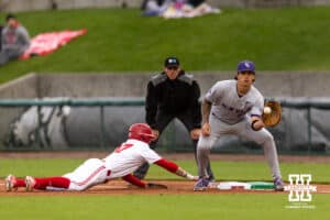 ebraska Cornhusker Mac Moyer (17) dives back to first against Kansas State Wildcat infielder Chandler Murray (52) in the first inning during a college baseball game at Haymarket Park on Tuesday, April 28, 2026, in Lincoln, Neb. Photo by John S. Peterson.