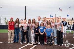 Creighton Bluejays head coach Krista Wood takes a photo with a team before a college softball game on April 28, 2026, in Omaha, Nebraska. Photo by Brandon Tiedemann.