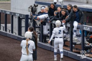 Creighton Bluejays bench high fives Zoey Greenwood (2) during a college softball game on April 28, 2026, in Omaha, Nebraska. Photo by Brandon Tiedemann.