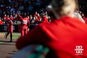 Nebraska batter Ava Kuzsak (7) high fives her teammate Samantha Bland (29) on the ay back to the dugout after a score during a college women’s softball game, Apr. 24, 2026, Lincoln, Nebraska. Photo by Braden Cochran.