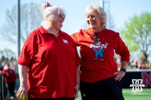Former Nebraska softball player Kim Schellpeper talks with head coach Rhonda Revelle before her first pitch during a college women’s softball game, Apr. 24, 2026, Lincoln, Nebraska. Photo by Braden Cochran.