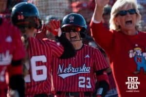 Nebraska Hannah Coor (23) celebrates a run at home plate with her team during a college women’s softball game, Apr. 24, 2026, Lincoln, Nebraska. Photo by Braden Cochran.