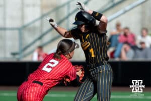 Nebraska second baseman Lauren Camenzind (2) attempts to tag out Iowa base runner Tory Bennett (1) during a college women’s softball game, Apr. 24, 2026, Lincoln, Nebraska. Photo by Braden Cochran.