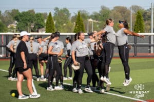Omaha Mavericks chest bump before a college softball game against Nebraska on April 21, 2026, in Omaha, Nebraska. Photo by Brandon Tiedemann