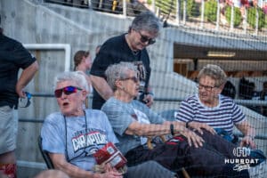 Omaha Softball legend Connie Claussen sits during a college softball game against Nebraska on April 21, 2026, in Omaha, Nebraska. Photo by Brandon Tiedemann