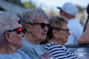 Omaha Softball legend Connie Claussen sits during a college softball game against Omaha on April 21, 2026, in Omaha, Nebraska. Photo by Brandon Tiedemann