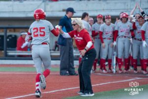 Nebraska Cornhusker Jesse Farrell (25) fist bumps Rhonda Revelle during a college softball game against Omaha on April 21, 2026, in Omaha, Nebraska. Photo by Brandon Tiedemann