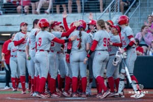 Nebraska Cornhuskers celebrate an Ava Kuszak (7) homerun during a college softball game against Omaha on April 21, 2026, in Omaha, Nebraska. Photo by Brandon Tiedemann